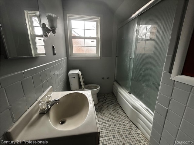15451 Prest St, Detroit, MI 48227 - bathroom with tile walls, enclosed tub / shower combo, vanity, tile patterned flooring, and a wainscoted wall