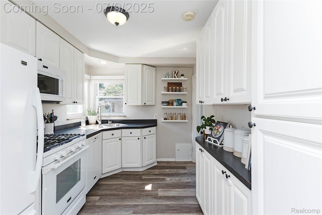 437 Normandy Rd, Royal Oak, MI 48073 - kitchen with white appliances, dark countertops, white cabinetry, dark wood-type flooring, and open shelves