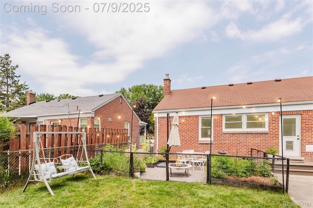 437 Normandy Rd, Royal Oak, MI 48073 - rear view of property with brick siding, a chimney, a fenced backyard, a patio area, and an outdoor fire pit