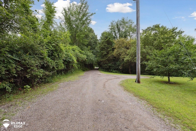 7266 Dodge Rd, Montrose, MI 48457 - view of dirt / gravel road with a wooded view