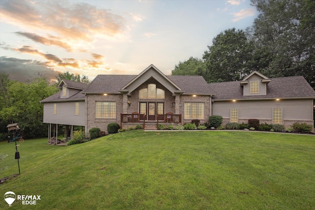 7266 Dodge Rd, Montrose, MI 48457 - view of front facade featuring brick siding, a front yard, a deck, and roof with shingles