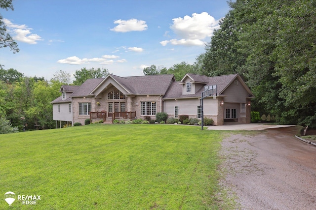 7266 Dodge Rd, Montrose, MI 48457 - view of front of home featuring french doors, a front yard, brick siding, and gravel driveway
