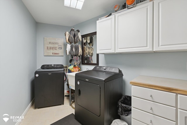 7266 Dodge Rd, Montrose, MI 48457 - laundry area featuring washing machine and clothes dryer, cabinet space, and light tile patterned floors