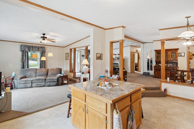 10224 Rexford Rd, Grass Lake, MI 49240 - kitchen featuring a ceiling fan, light carpet, open floor plan, ornamental molding, and a kitchen island