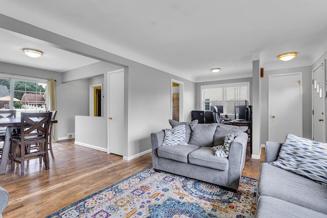 723 S Bowen St, Jackson, MI 49203 - living room featuring wood finished floors and an office area