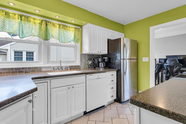 723 S Bowen St, Jackson, MI 49203 - kitchen featuring dishwasher, freestanding refrigerator, dark countertops, tasteful backsplash, and recessed lighting
