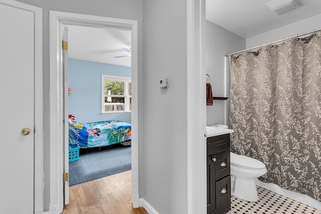 723 S Bowen St, Jackson, MI 49203 - bathroom featuring vanity, wood finished floors, curtained shower, and ceiling fan