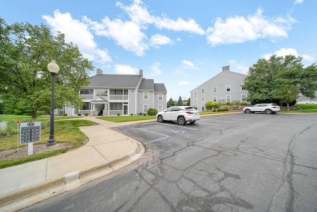 824 W Barrington Cir, Jackson, MI 49203 - view of asphalt road with curbs, street lighting, and sidewalks