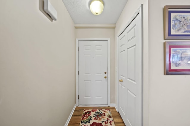 824 W Barrington Cir, Jackson, MI 49203 - doorway to outside with wood finished floors and baseboards
