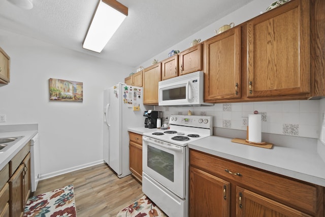 824 W Barrington Cir, Jackson, MI 49203 - kitchen with white appliances, light wood-style flooring, backsplash, light countertops, and brown cabinetry