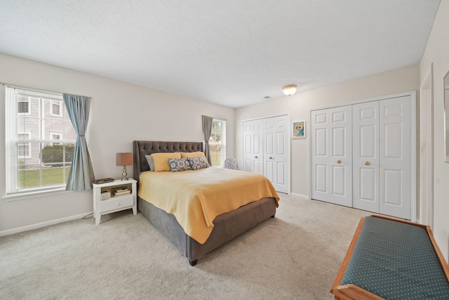 824 W Barrington Cir, Jackson, MI 49203 - carpeted bedroom featuring two closets and multiple windows