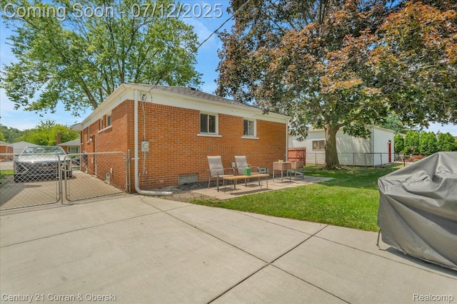 23139 Deziel St, Saint Clair Shores, MI 48082 - rear view of house featuring brick siding, a gate, a patio, and driveway