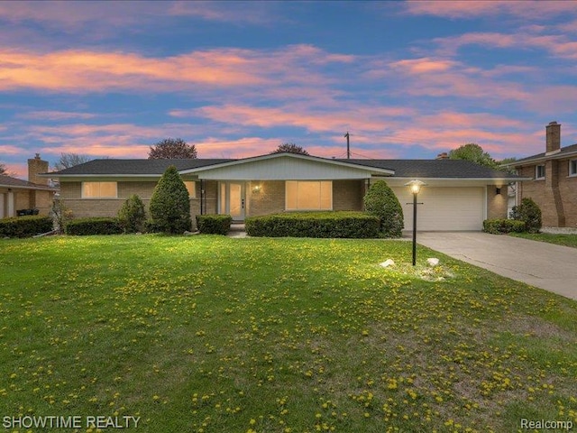 37305 Maas Dr, Sterling Heights, MI 48312 - single story home with a garage, brick siding, a yard, and concrete driveway