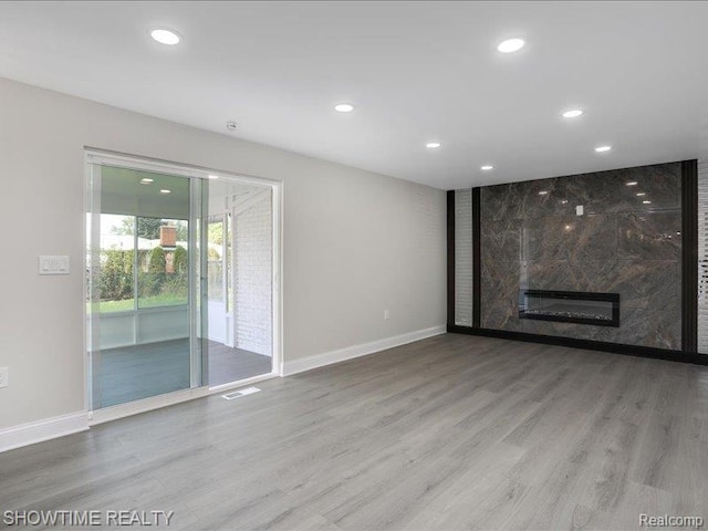 37305 Maas Dr, Sterling Heights, MI 48312 - unfurnished living room featuring recessed lighting, wood finished floors, and a fireplace