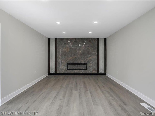 37305 Maas Dr, Sterling Heights, MI 48312 - unfurnished living room featuring recessed lighting, wood finished floors, and a premium fireplace