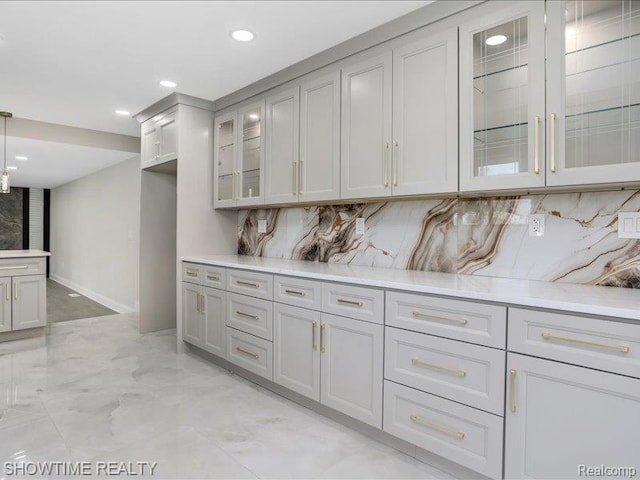 37305 Maas Dr, Sterling Heights, MI 48312 - kitchen with light countertops, decorative backsplash, recessed lighting, glass insert cabinets, and light marble finish floors
