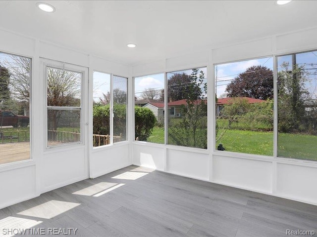 37305 Maas Dr, Sterling Heights, MI 48312 - unfurnished sunroom with recessed lighting, healthy amount of natural light, wood finished floors, and a decorative wall