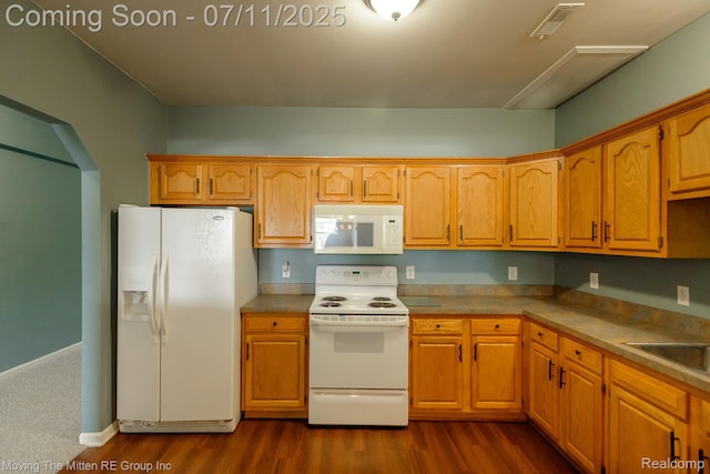 231 Main St, Belleville, MI 48111 - kitchen featuring white appliances, dark wood-style flooring, and brown cabinetry