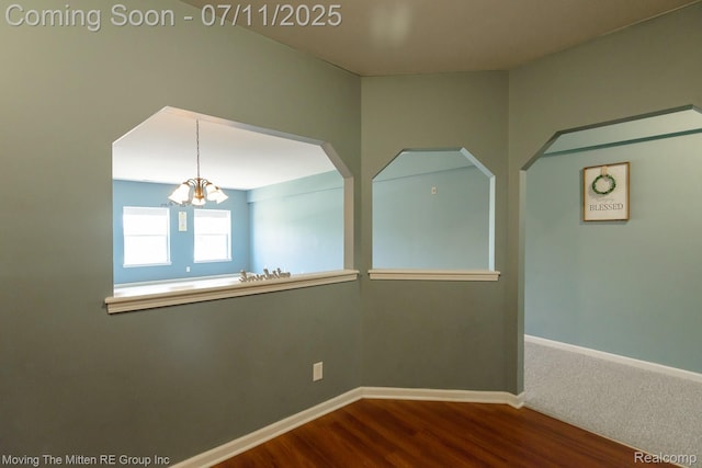 231 Main St, Belleville, MI 48111 - unfurnished room featuring a chandelier and dark wood-type flooring