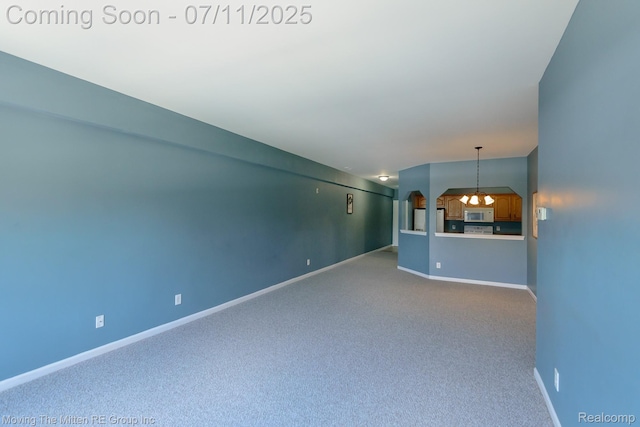 231 Main St, Belleville, MI 48111 - unfurnished living room with carpet floors and baseboards