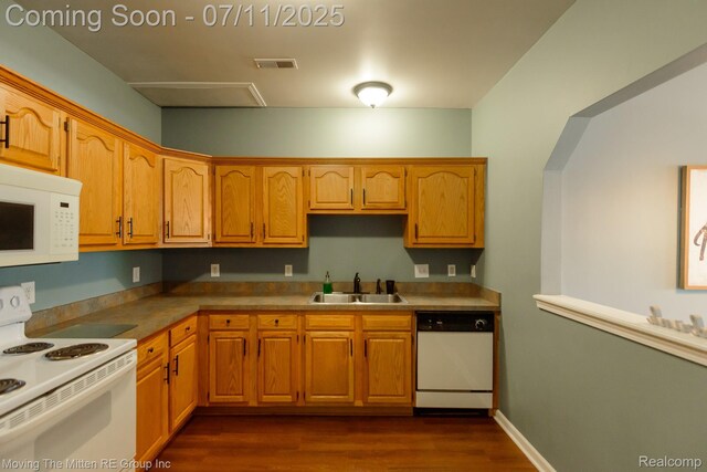231 Main St, Belleville, MI 48111 - kitchen with white appliances, dark wood-style floors, and brown cabinets