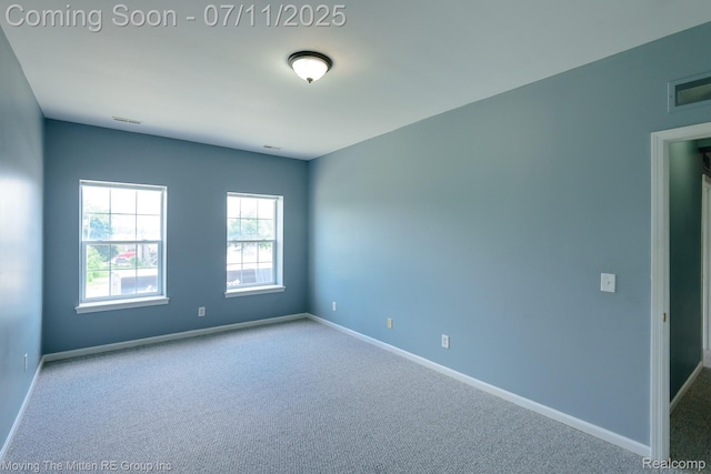 231 Main St, Belleville, MI 48111 - carpeted empty room featuring baseboards