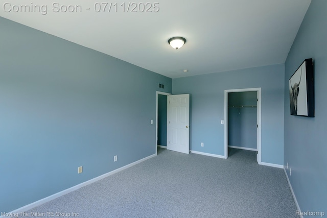 231 Main St, Belleville, MI 48111 - unfurnished bedroom with carpet flooring and a walk in closet