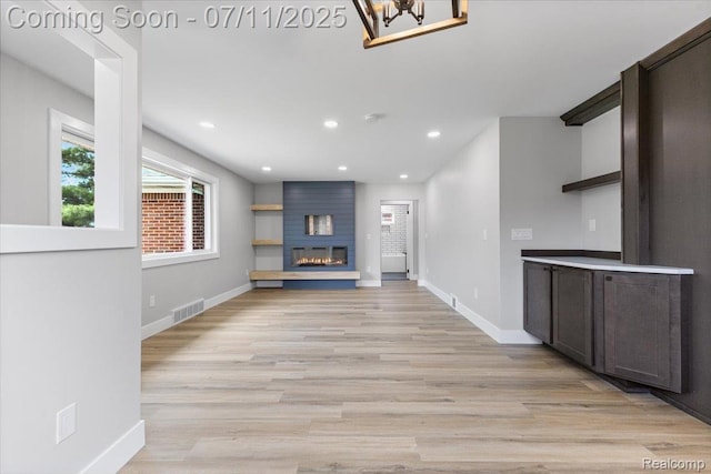 22700 Garfield St, Saint Clair Shores, MI 48082 - unfurnished living room featuring light wood-style floors, a large fireplace, a chandelier, and recessed lighting