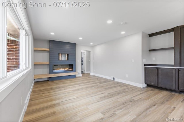 22700 Garfield St, Saint Clair Shores, MI 48082 - unfurnished living room with light wood-style flooring, a large fireplace, and recessed lighting