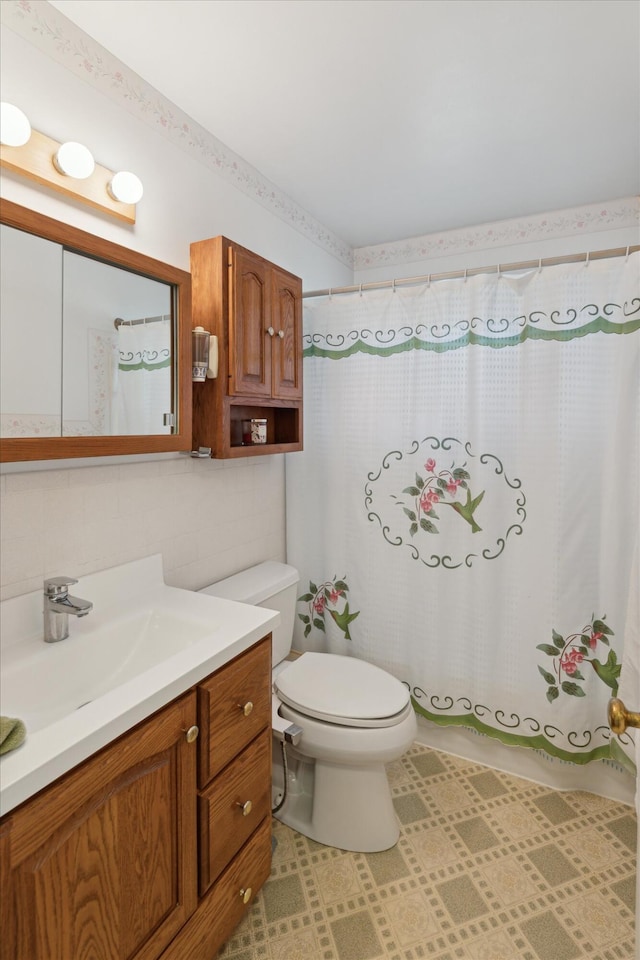 5452 Lucerne Ave, Kalamazoo, MI 49048 - full bath featuring vanity, a shower with shower curtain, tile patterned floors, and tile walls
