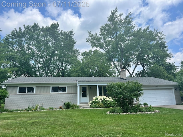 28164 Kendallwood Dr, Farmington Hills, MI 48334 - view of front facade featuring brick siding, a garage, a front lawn, a chimney, and driveway