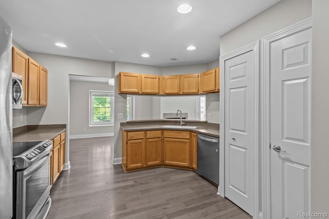 4350 Pine Ridge Ct, Ann Arbor, MI 48105 - kitchen featuring appliances with stainless steel finishes, wood finished floors, recessed lighting, and dark countertops