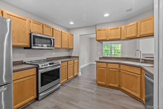 4350 Pine Ridge Ct, Ann Arbor, MI 48105 - kitchen featuring appliances with stainless steel finishes, light wood-type flooring, dark countertops, and recessed lighting
