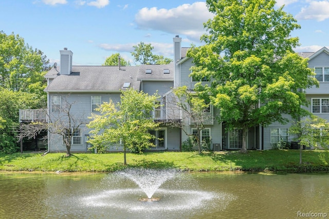 4350 Pine Ridge Ct, Ann Arbor, MI 48105 - rear view of house with a yard, a water view, and a chimney