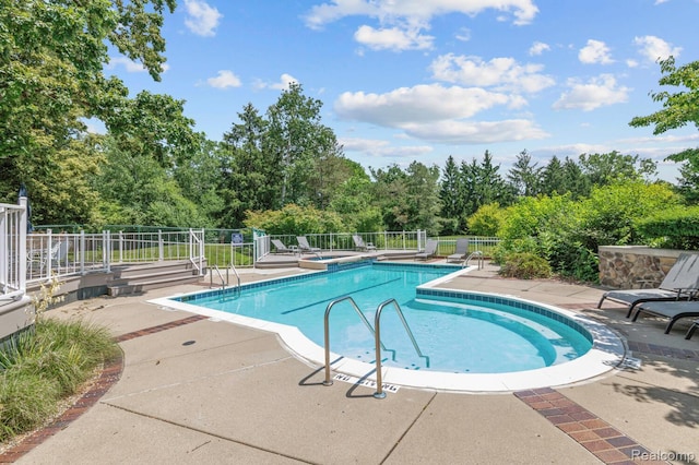4350 Pine Ridge Ct, Ann Arbor, MI 48105 - community pool with a patio area, view of scattered trees, and a jacuzzi