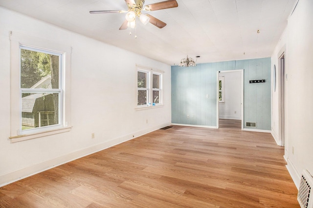 100 Eldred St, Battle Creek, MI 49015 - empty room with a chandelier, light wood-style floors, and ceiling fan