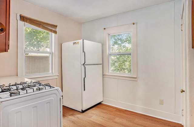 100 Eldred St, Battle Creek, MI 49015 - kitchen featuring white appliances and light wood-type flooring