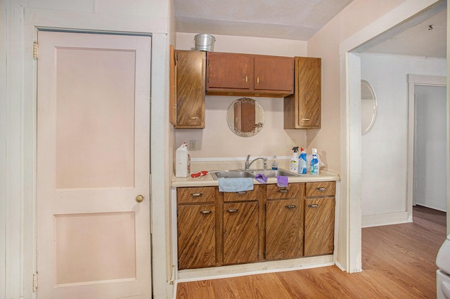100 Eldred St, Battle Creek, MI 49015 - kitchen featuring brown cabinetry, light wood-style floors, and light countertops
