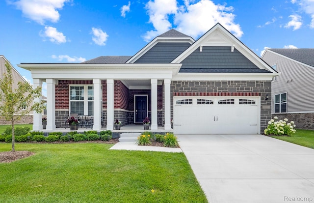 49976 Kent Ct, Canton, MI 48188 - view of front of property featuring an attached garage, a front lawn, covered porch, driveway, and stone siding