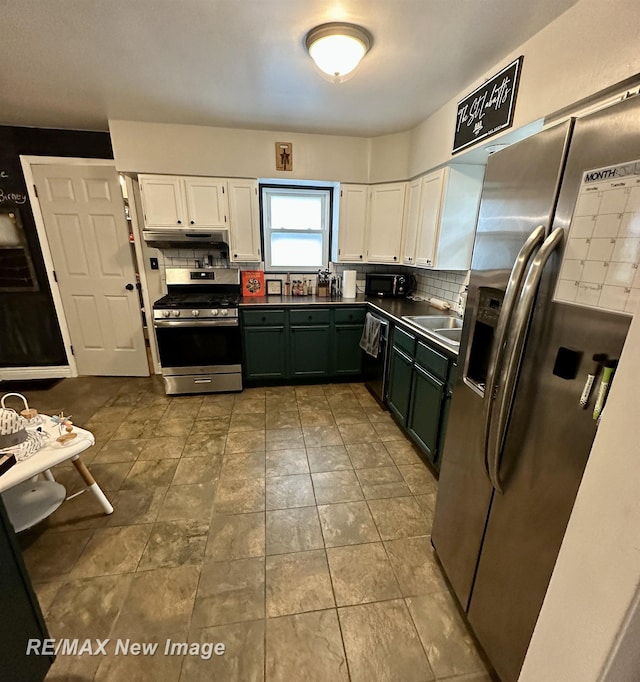 419 N Birney St, Bay City, MI 48708 - kitchen featuring appliances with stainless steel finishes, white cabinetry, decorative backsplash, and dark countertops