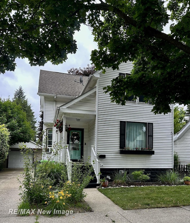 419 N Birney St, Bay City, MI 48708 - view of front facade featuring an outbuilding, roof with shingles, and driveway