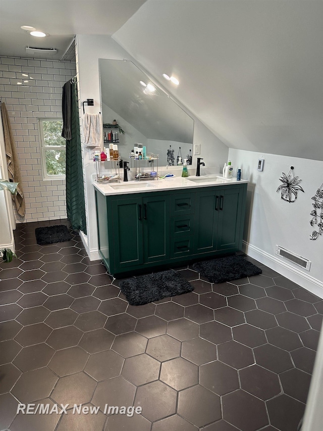 419 N Birney St, Bay City, MI 48708 - bathroom with vaulted ceiling, a shower stall, and double vanity