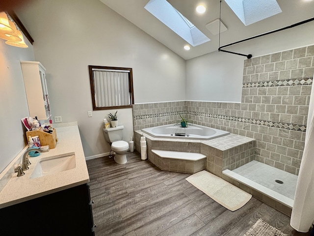 12141 Lawrence Rd, Brooklyn, MI 49230 - full bath featuring a skylight, wood finished floors, vanity, a garden tub, and a tile shower
