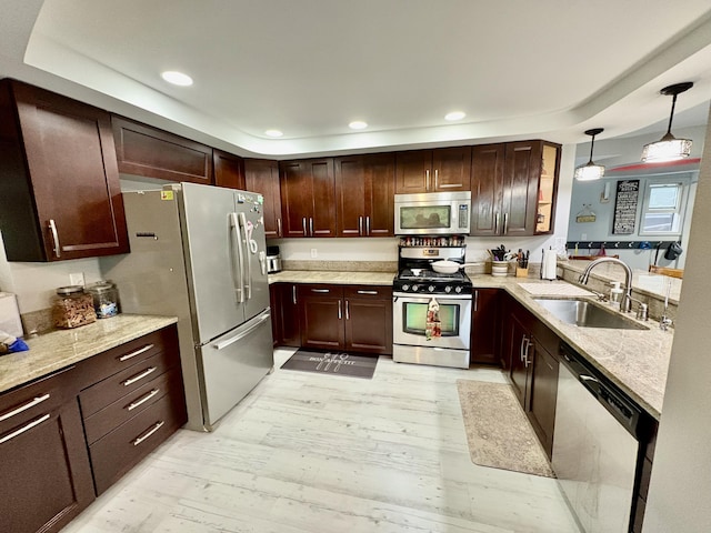 12141 Lawrence Rd, Brooklyn, MI 49230 - kitchen with appliances with stainless steel finishes, light wood-style flooring, decorative light fixtures, recessed lighting, and light stone countertops