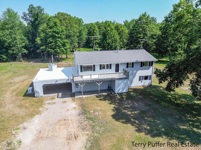 2860 Fenner Rd, Muskegon, MI 49445 - view of front of house featuring dirt driveway, a front lawn, and a deck