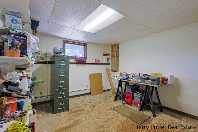 2860 Fenner Rd, Muskegon, MI 49445 - basement featuring a paneled ceiling and a baseboard heating unit