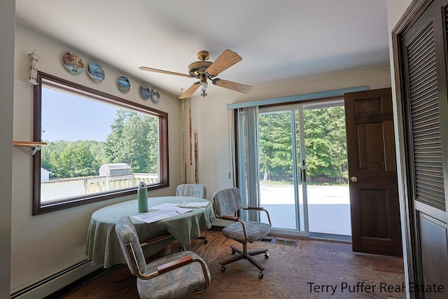 2860 Fenner Rd, Muskegon, MI 49445 - dining room with a ceiling fan, dark wood finished floors, and a baseboard heating unit