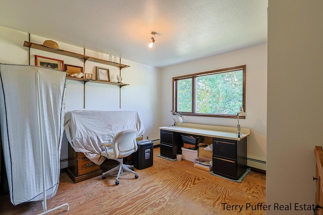 2860 Fenner Rd, Muskegon, MI 49445 - office area with baseboard heating, light wood-type flooring, and a textured ceiling