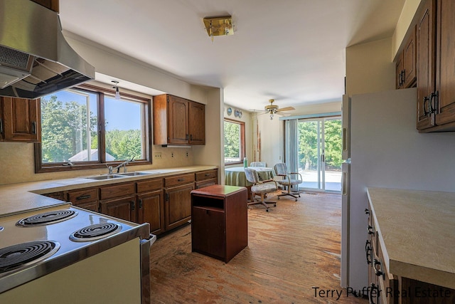 2860 Fenner Rd, Muskegon, MI 49445 - kitchen featuring ventilation hood, electric stove, light countertops, wood finished floors, and freestanding refrigerator