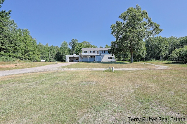 2860 Fenner Rd, Muskegon, MI 49445 - view of front of property featuring dirt driveway, a front yard, and a forest view